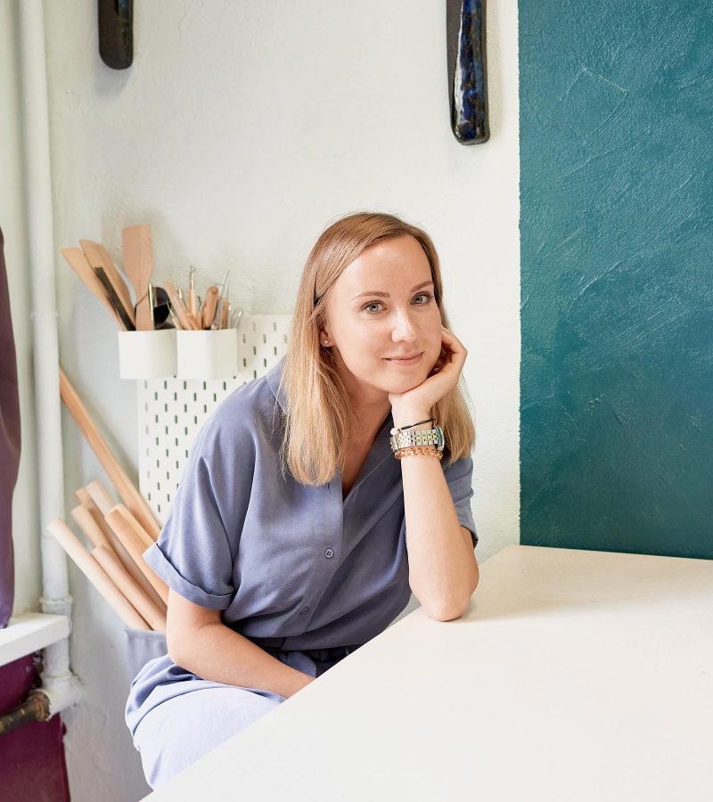 business-woman-sitting-at-table-and-smiling-in-cer-ZVJK2JG.jpg